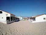 caption: Living next to the ocean sounds heavenly, but in this case the buildings were constructed on the dunes. Two thirds of the settlements territory lies on the dune, which had to be destroyed for the sake of man-made living. (Türkoglu, 2019)