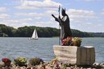 This is a monument of John Paul II (Poland, city of Olsztyn). From the historical and socio-political point of view, he played a great role in Poland. Above many other issues, he supported the transformation of Poland to become a democratic country. The regard and affection in which the people of Poland held and continue to hold John Paul II is extraordinary (in 1979 during his first visit as a pope, 13 million of Poles saw him in person). Before he died in 2005, there were 230 statues of him in Poland and after his dead this amount lifted to ca. 550 (there are about 200 monuments in other parts of the world overall). Monuments are well recognized and understandable, located in central parts of parks, squars, public areas. Are used by the public mainly as gather points to worship and memorialize. Picture taken in 1995, Olsztyn, Poland.