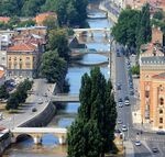 caption: The Miljacka is a rather small river, only 38 kilometres (24 mi) long with average discharge of 5.7 m³/s at the City of Sarajevo, and right tributary of the Bosna river. Hence the origin and the estuary, the Miljacka river flows from the east to the west.Due to Bosnian War water treatment was stopped and plant equipment looted preventing local government to deal with the issue as estimations to repair the wastewater plant run between 50 and 60 million euros.