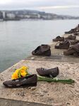 The Shoes on the Danube Bank is a memorial in Budapest, Hungary. Conceived by film director Can Togay, he created it on the east bank of the Danube River with sculptor Gyula Pauer to honour the Jews who were killed by fascist Arrow Cross militiamen in Budapest during World War II. They were ordered to take off their shoes, and were shot at the edge of the water so that their bodies fell into the river and were carried away. It represents their shoes left behind on the bank.