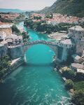 Stari Most, Old Bridge, is located in Mostar, Bosnia and Herzegovina, and is protected by UNESCO as a World Heritage site. It is a rebuilt 16th-century Ottoman bridge that crosses the river Neretva and connects the two parts of the city. The Old Bridge stood for 427 years, until it was destroyed on 9 November 1993 by Croat military forces during the Croat–Bosnian War. Subsequently, a project was set in motion to reconstruct it; the rebuilt bridge opened on 23 July 2004.